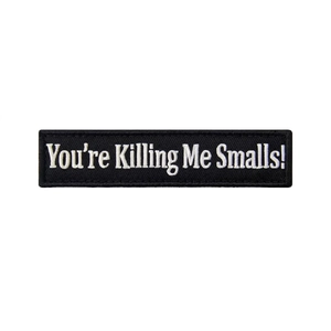 Close-up of You're Killing Me Smalls embroidery patch with detailed white stitching