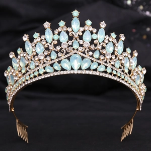 Detailed close-up of golden bridal tiara with light blue opals and crystal rhinestones
