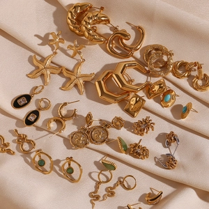 Flat lay of retro 18K gold plated hammered earrings on elegant champagne silk fabric