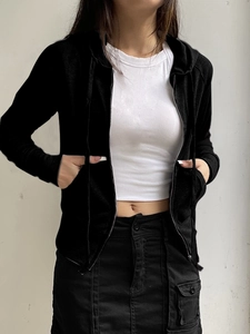 Detail shot of a black slim-fit hooded zip-up cardigan with premium textured fabric