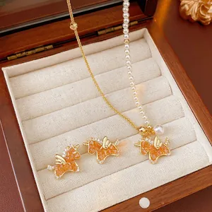 Elegant gold unicorn jewelry set featuring pearl stitching necklace and zircon earrings