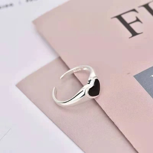 Detail shot of S925 sterling silver stamp and black enamel heart on adjustable ring
