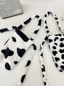 Plush cow print water bottle bag with crossbody strap and fluffy texture design