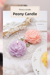 Detailed close-up of a lit purple peony-shaped scented candle on lace tablecloth