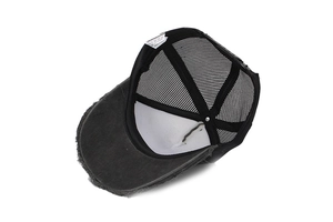 Detail view of distressed mesh baseball cap showing interior lining and care label