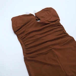 Detailed flat lay of dark brown strapless jumpsuit with side ruching and front cutout