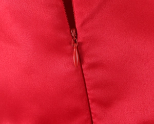 Detail of red satin fabric with matching concealed teardrop zipper for back closure