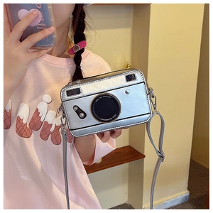 Detail showing retro silver camera-shaped PU leather crossbody bag with lettered lens