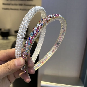 Detail of baroque crystal headbands featuring pearls and multi-colored rhinestones