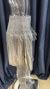 Detailed shot of silver metallic high-waisted shorts with elastic pleated waistband design