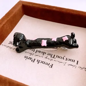 Resin dachshund hair clip with pink diamond patterns and silver metal duckbill clip