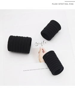Macro shot of 4cm black seamless plush elastic hair ties in a minimalist set of ten