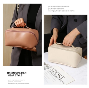 Detailed view of large-capacity PU leather cosmetic bags with sturdy handles and gold rivets