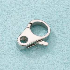 Macro shot of polished silver stainless steel lobster clasp on textured blue surface