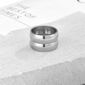 Polished silver stainless steel double-layered ring on a decorative stone base