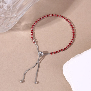 Detailed close-up of adjustable silver bracelet with 2.5mm red cubic zirconia stones