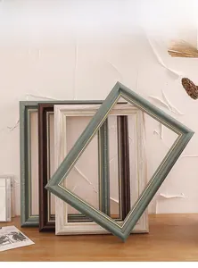 Detailed close-up of retro picture frames with gold beaded inner trim and wood textures