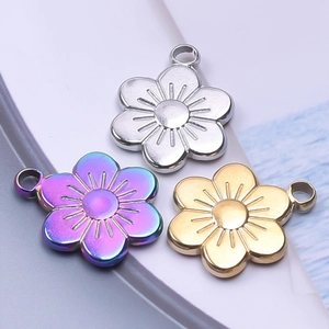 Three 18k plated stainless steel flower pendants in gold, silver, and iridescent purple