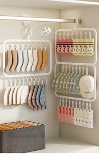 Multi-clip rotating white hanger for drying socks and hats in a neat closet setting