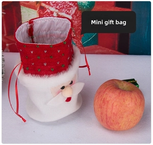 Close-up of Santa Claus drawstring gift bag with soft plush fabric and red ribbon tie