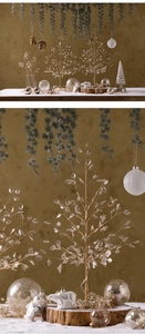 Close-up of golden branch with crystal acrylic leaves and wooden base Christmas decor