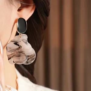 Artistic French resin flower earrings with marbled texture and black oval studs