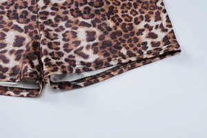 Detailed close-up of leopard print shorts hemline showing professional stitching craft