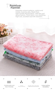 Close-up of three-color flannel pet blankets featuring cute paw prints and fine stitching