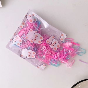 Macro detail of colorful high-elastic hair bands with a cute cartoon bear packaging bag