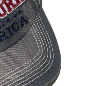 Detailed macro shot of vintage washed grey baseball cap with 3D embroidery and stitching