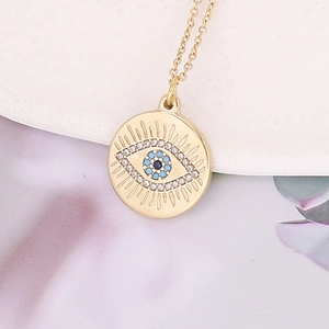 Golden Evil Eye pendant necklace with sparkling rhinestones and blue eye center detail