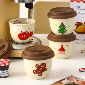 Christmas ceramic coffee cups with silicone lids featuring Santa and gingerbread man designs