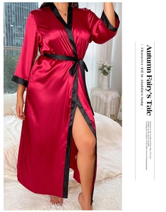 Detail of red satin robe with black trim showing fabric texture and tie-up design