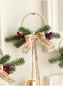 Close-up of Christmas bell with pine needles, red berries and Merry Christmas bow