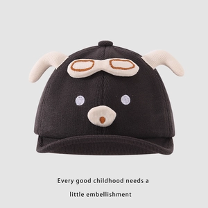 Close-up of baby pilot knit hat featuring cartoon animal ears and goggle embroidery