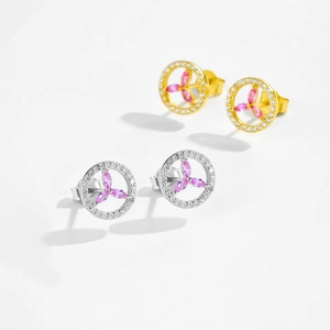 Detail of silver and gold round stud earrings with pink petal stones and white crystals