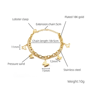 Close-up of double-layer 18K gold butterfly bracelet showing lobster clasp and extender chain