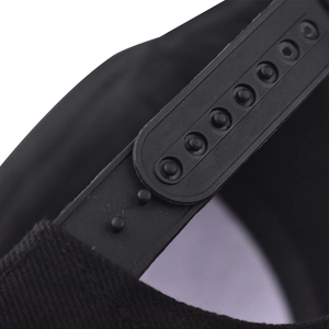 Detail van de verstelbare plastic snapback-sluiting op een zwarte katoenen baseballcap