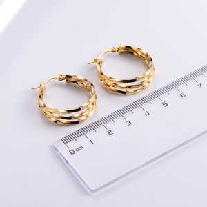Detailed view of 2cm twisted gold hoop earrings with multi-layered interwoven structure
