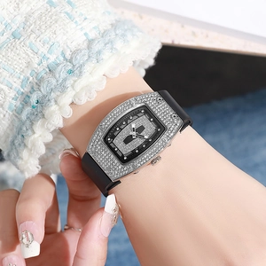 Fashionable tonneau diamond watch for women featuring a black silicone strap and crystal bezel