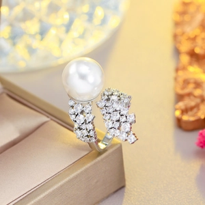 Macro view of luxury open ring with a round white pearl and shimmering zircon stones