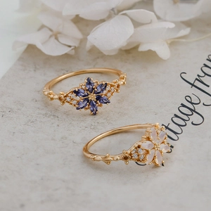 Close-up of S925 sterling silver rings with purple tanzanite and opal gemstones