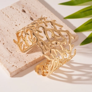 Detailed view of wide open cuff bracelet with organic coral texture on stone