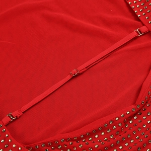 Detail of red mesh fabric featuring adjustable straps and sparkling rhinestone embellishments