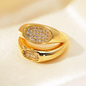 Close-up of double-layer gold open ring with micro-pave zircons on luxury silk fabric