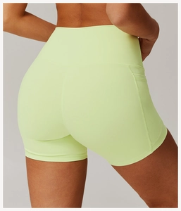 Close-up of lime green high-waisted gym shorts with ergonomic V-seam for butt-lifting