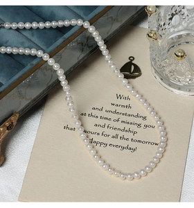 Detailed view of 5-6mm freshwater pearl necklace with S925 silver clasp on vintage jewelry box