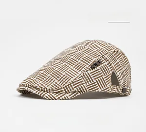 Detail of light khaki woven ivy cap with metal logo badge and textured mesh fabric