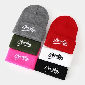 Knit Brooklyn beanies in multiple colors with classic cuffed design and embroidery