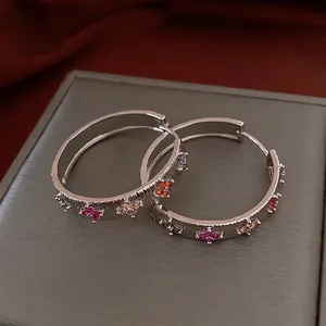 Silver brushed metal hoop earrings with colorful zircon floral accents for women